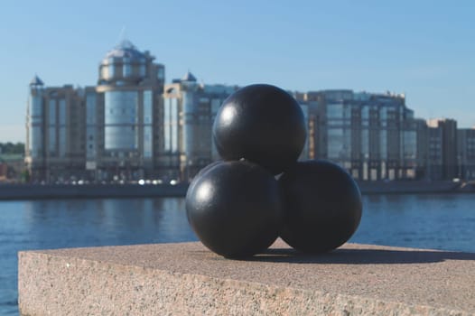 Old cannonballs on the embankment as a monument