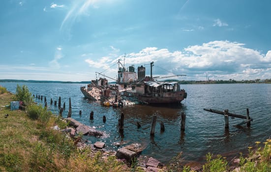 Abandoned ship in the bay on a summer day. sunken boat