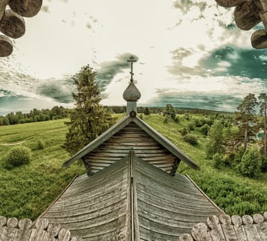 Old wooden church on the pasture field. rural panoramic landscape. roof of ancient chapel. traditional architecture
