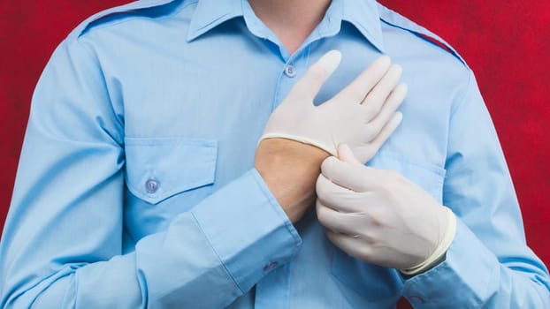 Man hands wearing the protective gloves. blue shirt worn by a man. formal clothing