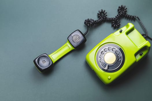 Classic phone with handset. vintage green telephone with phone receiver isolated on purple background. old communication technology. copy space