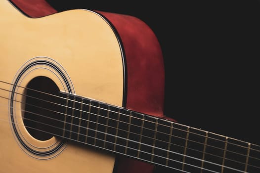 Guitar on the black background. acoustic musical instrument