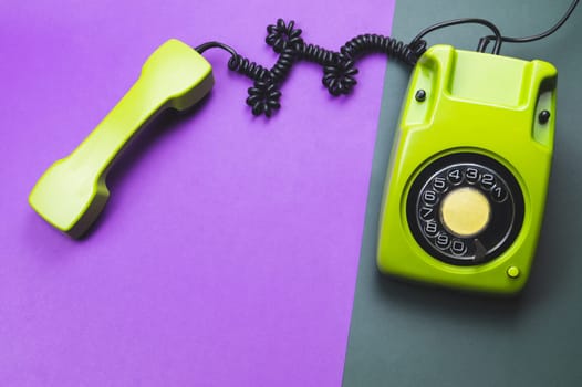 Classic phone with handset. vintage green telephone with phone receiver isolated on color background. old communication technology. copy space