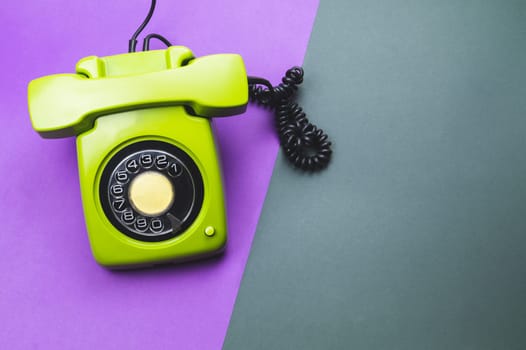 Classic phone with handset. vintage green telephone with phone receiver isolated on color background. old communication technology. copy space