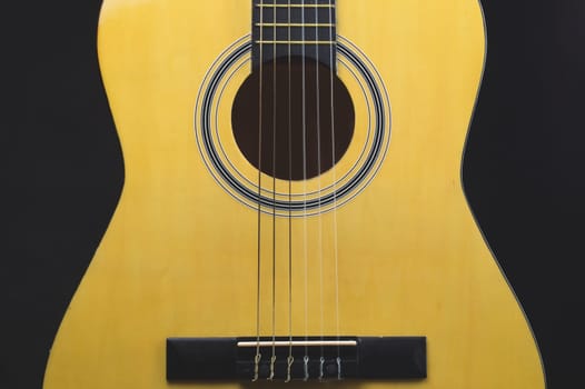 Guitar on the black background. acoustic musical instrument