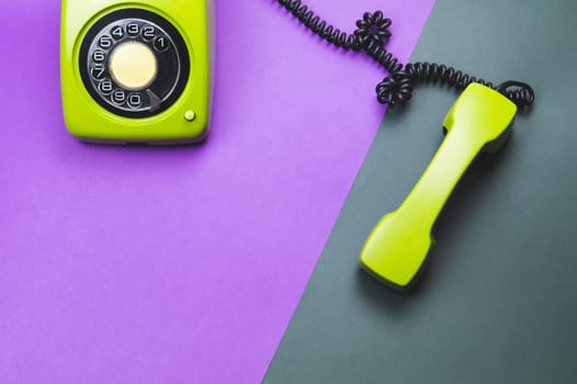 Classic phone with handset. vintage green telephone with phone receiver isolated on color background. old communication technology. copy space