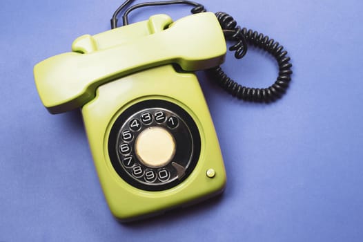 Classic phone with handset. vintage green telephone with phone receiver isolated on color background. old communication technology. copy space