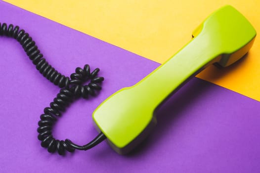Vintage green telephone handset. phone receiver on color background. old communication technology. copy space