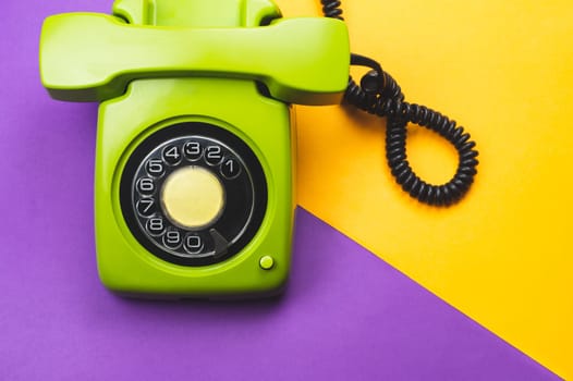 Classic phone with handset. vintage green telephone with phone receiver on color background. old communication technology. copy space