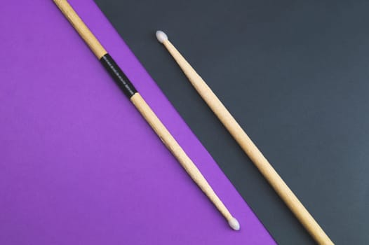 A pair of wooden drumsticks isolated on color background. copy space