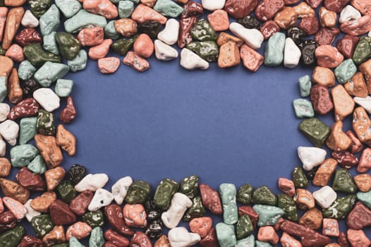 Candy pebbles. sweets in the form of colored stones. frame made from colorful candies