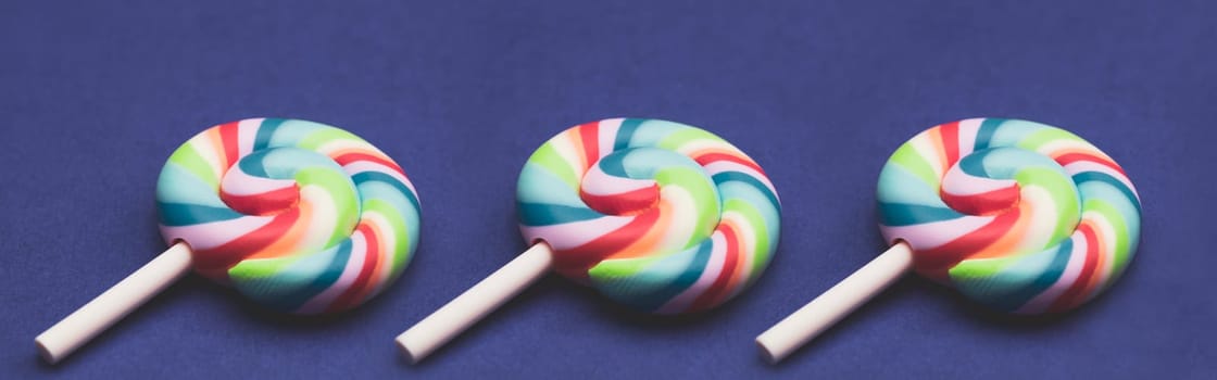 Colorful candies. lollipops isolated on colored background. festive concept. copy space