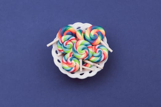 Lollipops close up. colorful candies on a blue background. festive decoration. copy space
