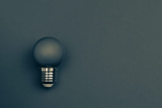 Single light bulb painted in color with background. copy space