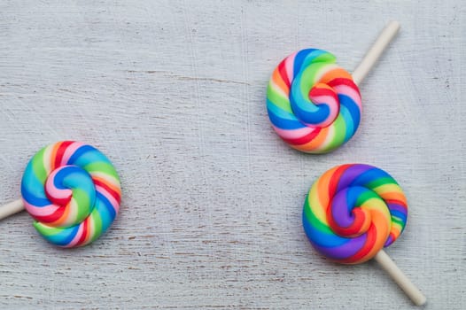Lollipops on white wooden background. colorful candies close up. copy space