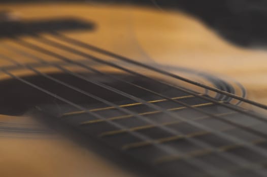 Acoustic guitar in smoke close up. musical instrument. strings on the guitar fretboard