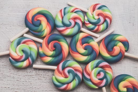 Lollipops on white wooden background. colorful candies close up