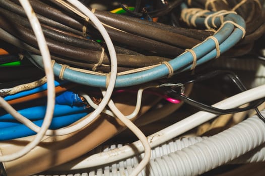Used electric colorful wires. hank of different old cables close up