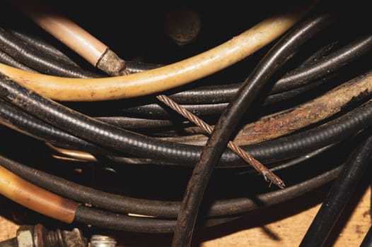 Used electric colorful wires. hank of different old cables close up
