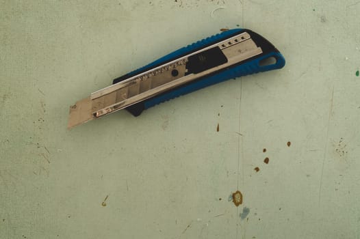 Stationery knife on the wooden floor. cutter knife on the working surface. copy space