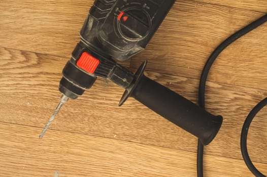 Electric drill on the floor. repair process. work tool