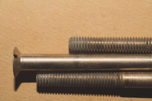 Screws on a cardboard background. work tool
