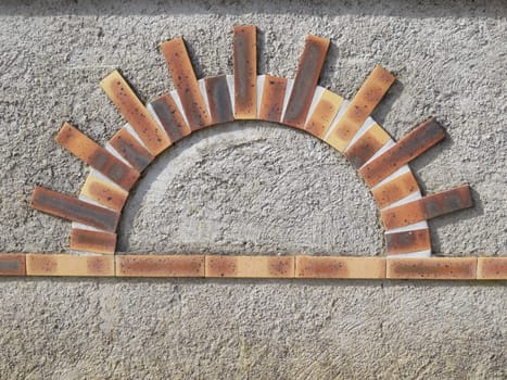 beautiful figure made with sun-shaped bricks colors building materials