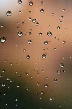 Raindrops on window glass close up. water drops macro background
