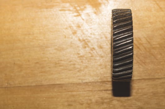 Metal gear on a wooden background. detail of mechanism