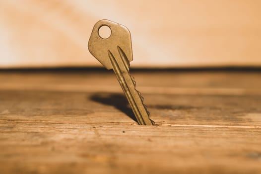 Key stuck in the table. key on wooden background. safety and security concept
