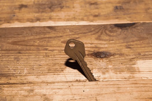 Key stuck in the table. key on wooden background. safety and security concept
