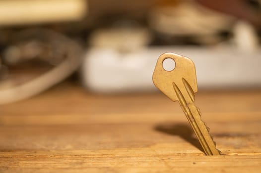 Key stuck in the table. key on wooden background. safety and security concept