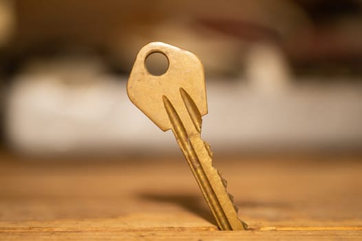 Key stuck in the table. key on wooden background. safety and security concept