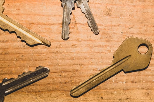 Different keys on wooden background. safety and security concept