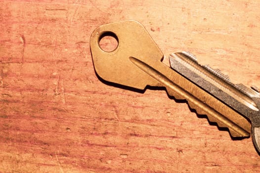 Pair of keys isolated on wooden background. safety and security concept. copy space