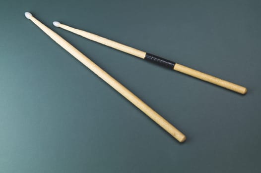 A pair of wooden drumsticks isolated on color background. copy space