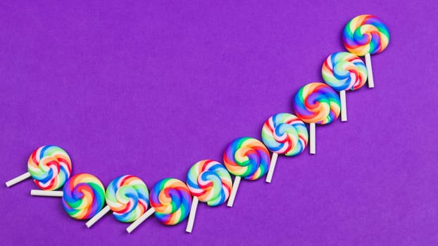 Colorful candies. lollipops isolated on color background. festive concept. copy space