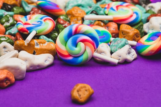 Lollipops and candy pebbles. sweets in the form of colored stones. colored background with colorful candies. festive decoration