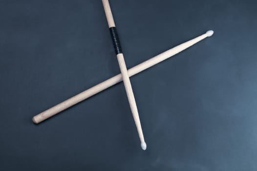 A pair of wooden drumsticks isolated on color background. copy space
