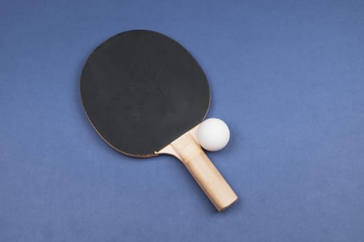 Black ping pong racket with a ball isolated on a color background. sport equipment for table tennis