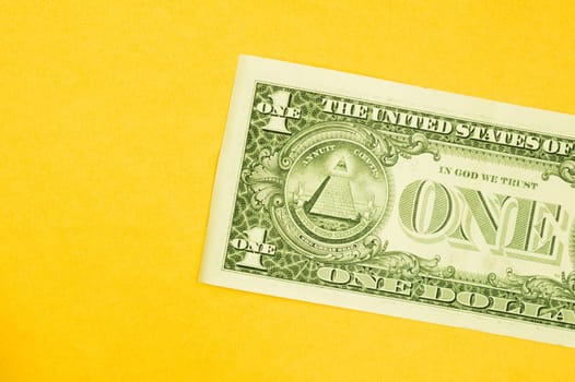 One dollar bill isolated on yellow background