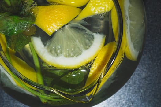 Drink with lemon and mint. homemade lemonade. glass jug with refreshing beverage