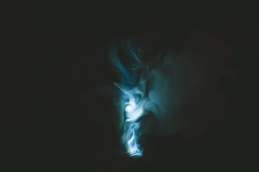 Turquoise smoke on black backdrop. color fog abstract background
