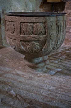 Caceres, Spain - Jan 14th, 2021: Baptismal font of Church of Santiago, early site of the Military Order of the Knights of Santiago. Caceres, Extremadura, Spain