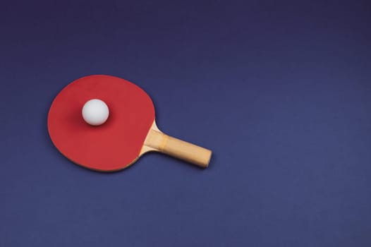 Red table tennis racket with a ball isolated on a colored background. sport equipment for ping pong. copy space