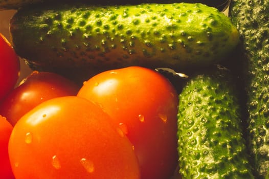 Tomatoes and cucumbers close up. ripe vegetables. healthy vegetarian organic food