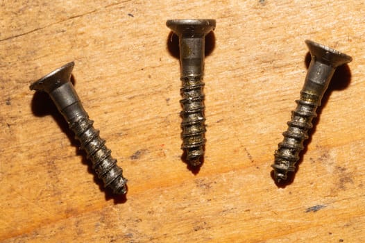 Screws on a wooden background.working tools. copy space