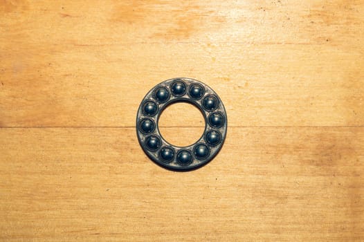 Metal bearing on a wooden table close up