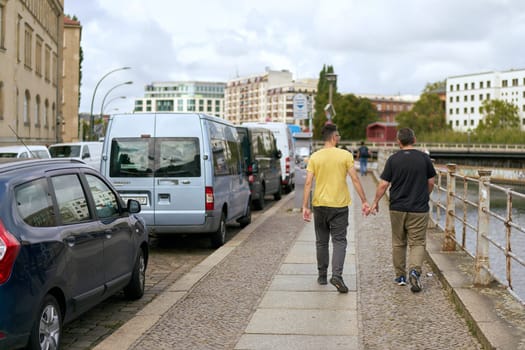 Street scene in downtown Berlin with homosexual couple on a sidewalk
