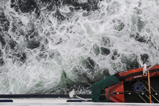 Big water splash seen from above a boat